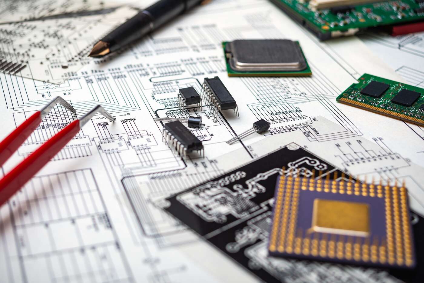 Electronic Components and Tools on an Engineering Blueprint for Circuit Board Design Image